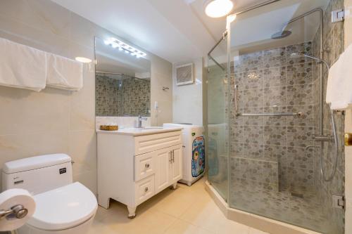 a bathroom with a shower and a toilet and a sink at Homestay coco in Vung Tau