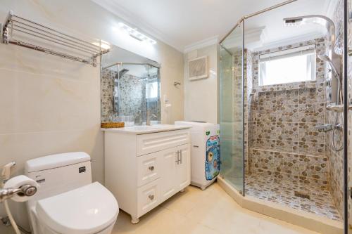 a bathroom with a shower and a toilet and a sink at Homestay coco in Vung Tau