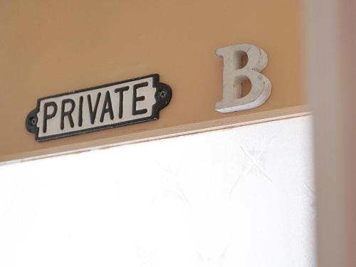 a sign that says private above a window at Guest House Kadoyasu in Kanazawa