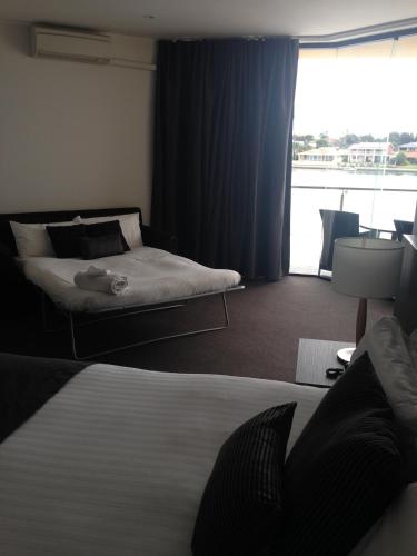 a hotel room with a bed and a window at Lakes Hotel in Adelaide