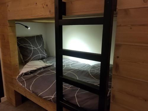 a bunk bed in a room with a bed in it at Magnifique Vue Centre Station in Les Deux Alpes