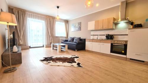 a large living room with a couch and a kitchen at City Apartment Alici in Füssen