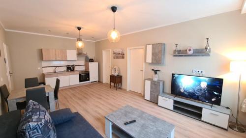 a living room with a large flat screen tv at City Apartment Alici in Füssen