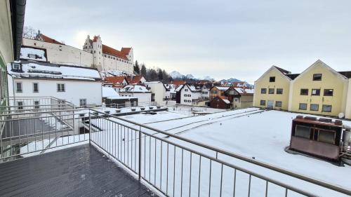 a city with snow on the roofs of buildings at City Apartment Alici in Füssen