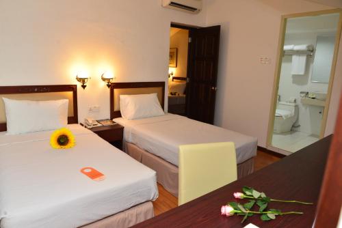 Postel nebo postele na pokoji v ubytování Cheng Ho Hotel