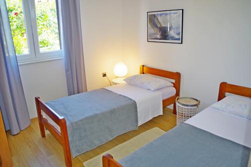 מיטה או מיטות בחדר ב-Apartment Luciana
