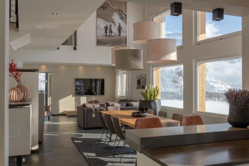 a kitchen and living room with a table and chairs at Chalet Isabella in Kaltenbach