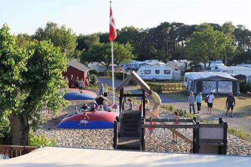 a group of people playing in a playground at Hasle Camping & Hytter in Hasle