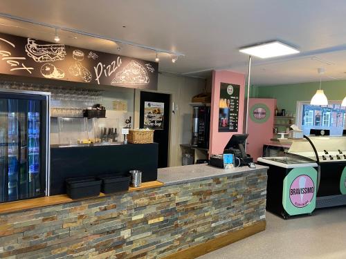 a fast food restaurant with a counter and a bar at Hasle Camping & Hytter in Hasle