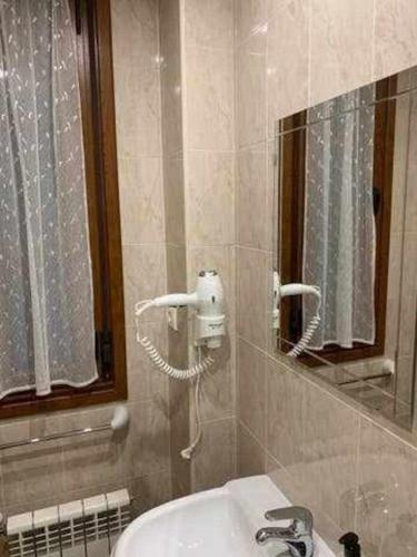 a bathroom with a sink and a mirror at Cumbres de los Picos Apartamento Urriellu in Poo de Cabrales
