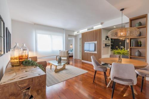 a living room with a table and a dining room at Madrid Rental Flats in Madrid