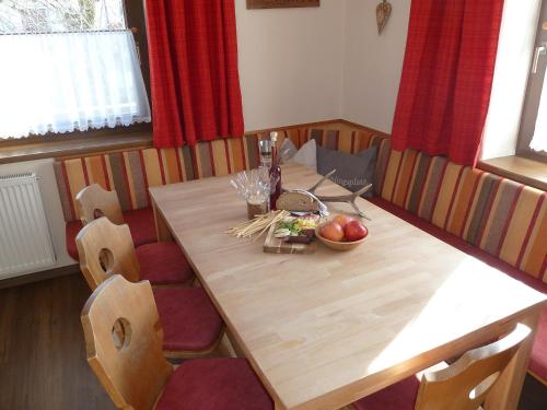 a wooden table with a bowl of fruit on it at Appartement Hauser in Stumm