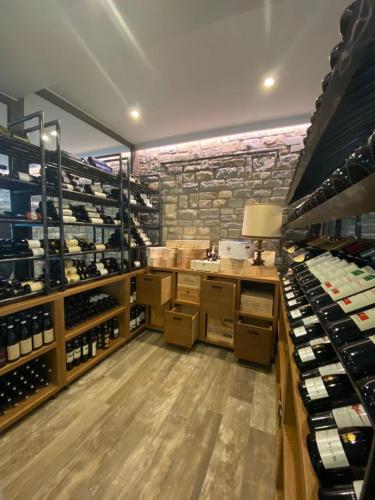 a wine shop with a large room filled with wine bottles at Hotel Rioverde in Pralormo