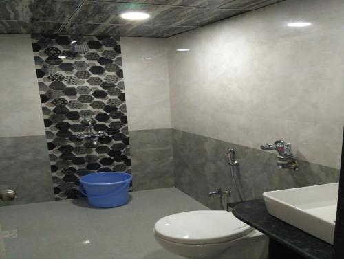 a bathroom with a toilet and a sink at Happy Stay Near Airport Pune in Pune