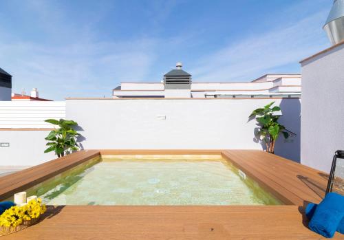 a swimming pool on the roof of a house at Calafell Home Apartments in Calafell