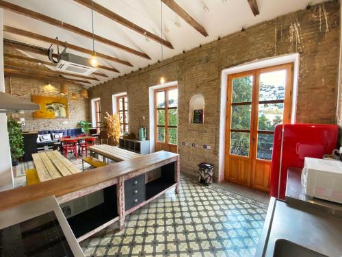 a kitchen with a table and a dining room at ECO Hostel in Granada
