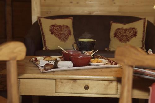 a table with a tray of food on it at Hôtel Spa Crychar in Les Gets