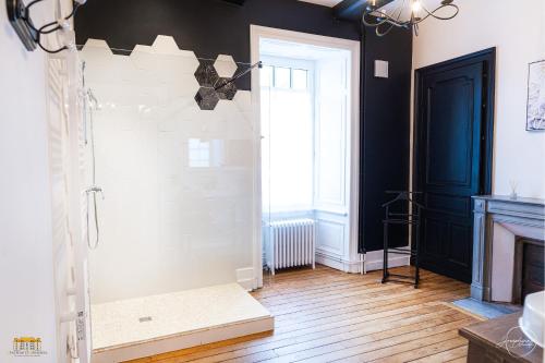 a bathroom with black and white walls and a fireplace at Château d'Hermival in Hermival-les-Vaux