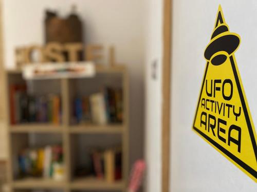 a yellow caution sign on a door in a room at ECO Hostel in Granada
