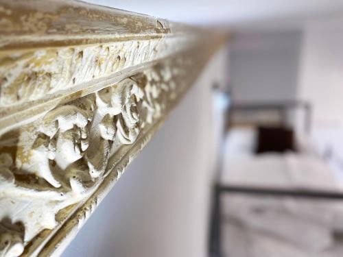 a close up of a gold object with writing on it at ECO Hostel in Granada