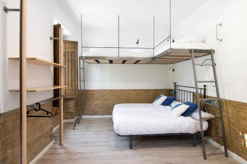 a bedroom with two bunk beds in a room at ECO Hostel in Granada