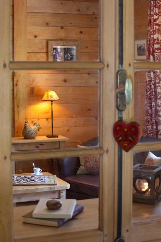 a wooden room with a table with a lamp in it at Hôtel Spa Crychar in Les Gets