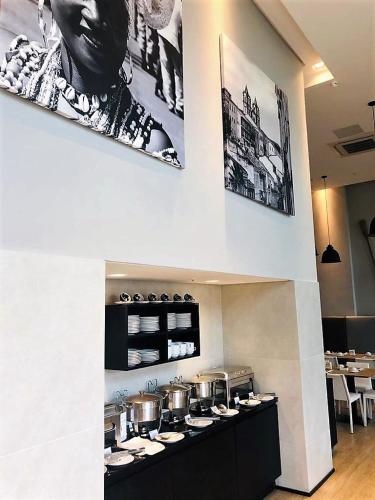 a kitchen with pots and pans on a counter at Astron Suítes Mondial Salvador by Nobile in Salvador