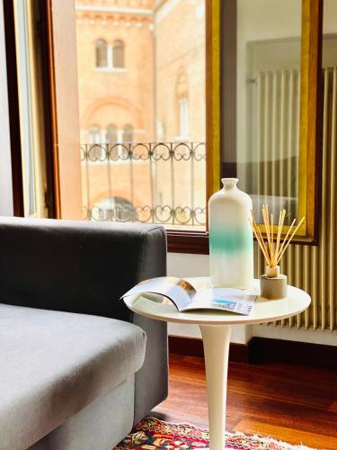 a table with a bottle on it next to a chair at Palazzina300 in Treviso