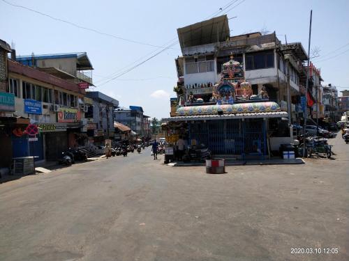 a street with a building in the middle of a city at AMINA LODGE in Port Blair