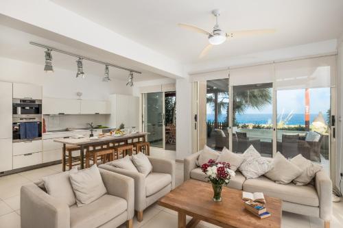 a living room with a couch and a table at House 7, The Artisan Resort in Protaras