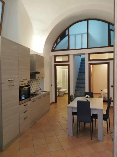 a kitchen with a table and some chairs in a room at Lo scorcio del Borgo in Atrani