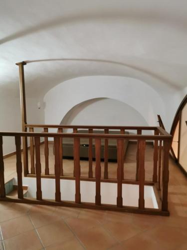 a wooden staircase in a building with an archway at Lo scorcio del Borgo in Atrani
