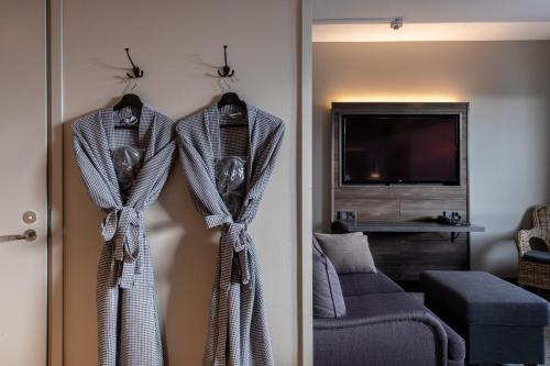 a living room with two coats hanging on a door at Lapland Hotels Kuopio in Kuopio