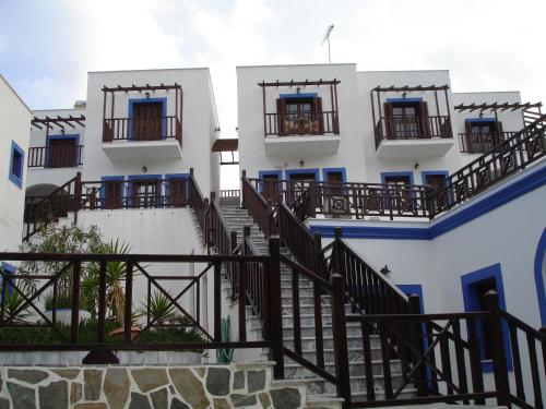 a building with stairs and balconies on it at Aphroditi Hotel in Lipsoi