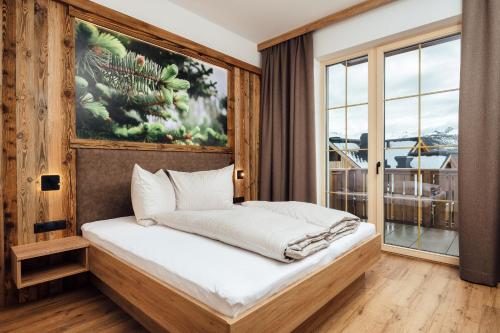 Кровать или кровати в номере Alpenheimat Laurschhof