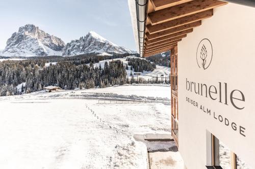 a sign for durango mountain lodge in the snow at Brunelle Seiser Alm Lodge in Alpe di Siusi