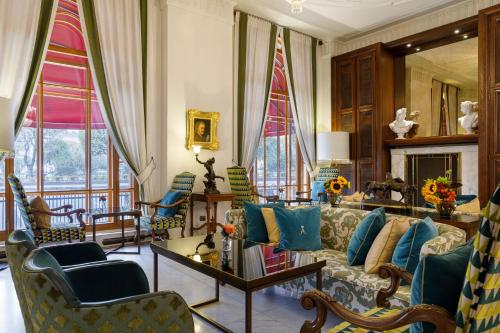 a living room with a couch and chairs at Rocco Forte Astoria Hotel in Saint Petersburg