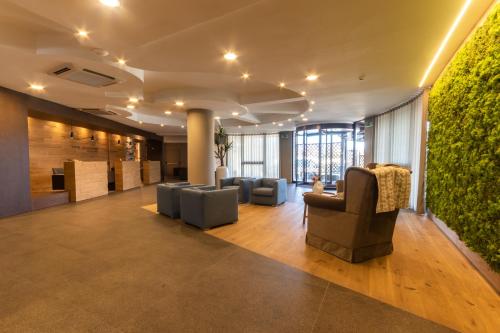 a lobby with couches and a green wall at Sport Village Hotel & Spa in Castel di Sangro