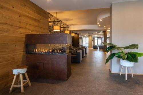 a lobby with a bar with a fireplace at Sport Village Hotel & Spa in Castel di Sangro