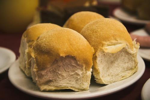 three sandwiches on a plate on a table at Hotel do Papa in Aparecida