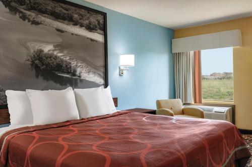 a hotel room with a bed and a window at Hometown Place in Olive Branch