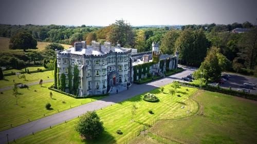 an aerial view of a large building in a park at Ballyseede Castle in Tralee