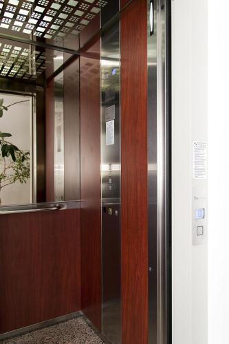 a wooden elevator in a building with a glass door at Hanul Domnesc in Braşov