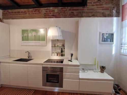 een keuken met witte kasten en een wastafel bij Luxury Loft 89 in Milaan