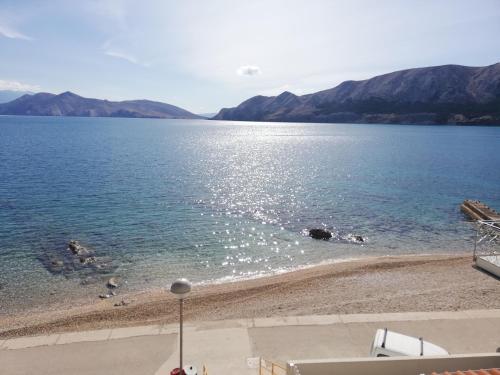 a view of a body of water with mountains at Apartments Luna in Baška