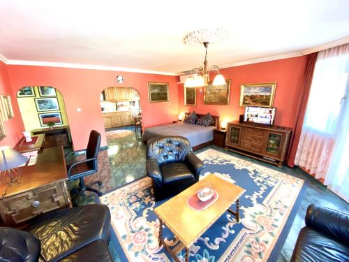 a living room with a couch and a bed at Zalár Apartman in Eger