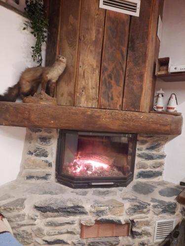 a stone fireplace with a fire in it at IL SANTO GRAAL in Triora