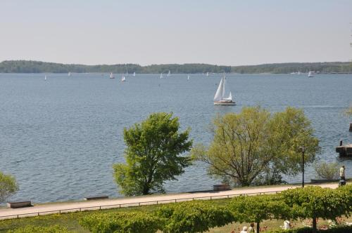 a sailboat on a lake with boats in the water at Pension Müritzblick in Waren