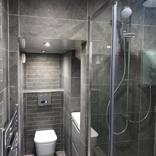 a bathroom with a toilet and a glass shower at Ashburn House in Fort William