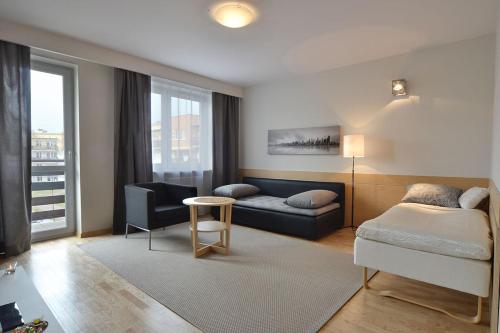 a living room with a bed and a couch at Apartament Classic in Kielce